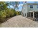 Long driveway showcasing the side of the two-story home, offering convenient access and ample parking at 6131 Central Ave, New Port Richey, FL 34653