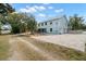 Wide angle of the home with an extensive driveway, lush lawns, and beautiful landscaping, creating curb appeal at 6131 Central Ave, New Port Richey, FL 34653