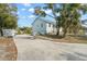 Exterior side view highlighting the two-car garage and landscaped yard, enhancing the home's curb appeal at 6131 Central Ave, New Port Richey, FL 34653