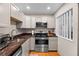 Modern kitchen featuring gray cabinets, granite countertops, and stainless steel appliances at 6131 Central Ave, New Port Richey, FL 34653