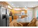 Bright kitchen with stainless steel appliances, wood cabinets, and a breakfast bar with seating at 6131 Central Ave, New Port Richey, FL 34653