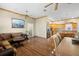 Cozy living room with wood floors flowing seamlessly into the kitchen at 6131 Central Ave, New Port Richey, FL 34653