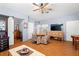 Cozy living room with hardwood floors, ceiling fan, and access to other rooms at 6131 Central Ave, New Port Richey, FL 34653
