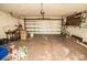 Garage with a closed overhead door, concrete floor and storage on the side at 625 Kingston Ct, Apollo Beach, FL 33572