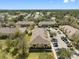 Community overview featuring yellow apartment buildings with trees and generous parking at 6262 Maisie Rd, Zephyrhills, FL 33542