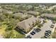 A beautiful aerial view of apartments with ample parking surrounded by green landscaping at 6262 Maisie Rd, Zephyrhills, FL 33542