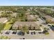 A beautiful aerial view of yellow apartments with ample parking and palm tree landscaping at 6262 Maisie Rd, Zephyrhills, FL 33542