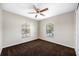 Bedroom featuring carpet floors, ceiling fan and natural light at 6262 Maisie Rd, Zephyrhills, FL 33542