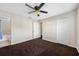 Comfortable bedroom with ceiling fan, neutral paint, and ensuite bathroom at 6262 Maisie Rd, Zephyrhills, FL 33542