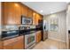 Modern kitchen featuring stainless steel appliances, granite countertops, and tile backsplash at 6262 Maisie Rd, Zephyrhills, FL 33542