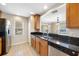 Kitchen featuring black countertops, stainless steel appliances, and tile floors at 6262 Maisie Rd, Zephyrhills, FL 33542