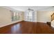 Inviting living room with hardwood floors, built-in shelving, ceiling fan, and stairs to upper level at 6262 Maisie Rd, Zephyrhills, FL 33542