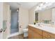 Bathroom featuring a glass shower, wood vanity, and neutral decor at 716 Cordova Grn, Seminole, FL 33777