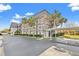 Exterior view of a multi-story building with palm trees and covered parking at 716 Cordova Grn, Seminole, FL 33777