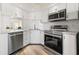 Bright, clean kitchen features stainless appliances, white subway tile backsplash, and sleek counters at 716 Cordova Grn, Seminole, FL 33777
