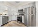 Updated kitchen featuring stainless steel appliances, white cabinets, and modern countertops at 716 Cordova Grn, Seminole, FL 33777