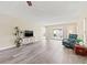 Comfortable living room with stylish flooring, a sliding glass door to an outside patio, and a ceiling fan at 716 Cordova Grn, Seminole, FL 33777