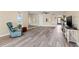 Spacious living room with wood floors, large mirror, and natural light at 716 Cordova Grn, Seminole, FL 33777