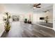 Bright and airy living room featuring wood floors and a wall mirror at 716 Cordova Grn, Seminole, FL 33777