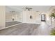 Open living area with neutral walls, sleek flooring, and large mirror creating an airy feel at 716 Cordova Grn, Seminole, FL 33777