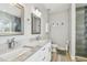 Bright bathroom with a double sink vanity, granite countertops, modern fixtures, and a glass-enclosed shower at 7403 S Obrien St, Tampa, FL 33616