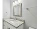 Clean bathroom featuring a stylish vanity with a granite countertop and chrome fixtures at 7403 S Obrien St, Tampa, FL 33616