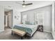 Bedroom with two windows, ceiling fan, and a neatly made bed with a bench at the end at 7403 S Obrien St, Tampa, FL 33616