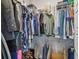 Walk-in closet with metal shelving filled with clothing, shoes, and boxes providing storage and organization at 7403 S Obrien St, Tampa, FL 33616