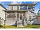 Exterior of a two-story home featuring a screened porch and backyard access at 7403 S Obrien St, Tampa, FL 33616