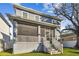 Exterior of a two-story home featuring a screened porch and stairs at 7403 S Obrien St, Tampa, FL 33616