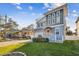 Beautiful two-story home with blue accents, well-manicured lawn, and a lovely brick driveway in a residential neighborhood at 7403 S Obrien St, Tampa, FL 33616