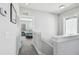 Hallway that opens to a bedroom and a view of the bed with a bench at the end at 7403 S Obrien St, Tampa, FL 33616