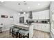 Modern kitchen with a granite island, stainless steel appliances, pendant lighting, and white cabinetry at 7403 S Obrien St, Tampa, FL 33616