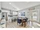 Bright kitchen and dining area featuring white cabinetry, stainless steel appliances, and a dining table for Gathering gatherings at 7403 S Obrien St, Tampa, FL 33616