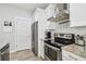 Well-equipped kitchen with stainless steel appliances, granite countertops, and ample cabinet space at 7403 S Obrien St, Tampa, FL 33616