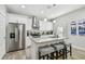 Stylish kitchen featuring an island with seating, stainless steel appliances, and white cabinets at 7403 S Obrien St, Tampa, FL 33616