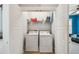 Convenient laundry closet with washer, dryer, shelving, and easy access to other areas at 7403 S Obrien St, Tampa, FL 33616