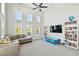 Bright living room featuring high ceilings, multiple windows, and a comfortable seating area, creating an inviting space at 7403 S Obrien St, Tampa, FL 33616