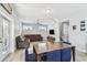 Cozy living room with a large sectional sofa, dining table, and stairs to the upper level at 7403 S Obrien St, Tampa, FL 33616