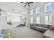 Spacious living room with a high ceiling, comfortable gray sectional sofa, and a view of the upstairs area at 7403 S Obrien St, Tampa, FL 33616