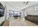 Open-concept living space with dining area, kitchen, wood-look tile flooring, and comfortable sofa at 7403 S Obrien St, Tampa, FL 33616