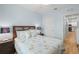 Bedroom featuring a nautical themed bedspread, lamps, and access to the kitchen at 7497 W Lenox Cir, Punta Gorda, FL 33950