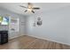 Cozy bedroom with a ceiling fan, bright window, and wood-style flooring, perfect for a restful retreat at 7497 W Lenox Cir, Punta Gorda, FL 33950