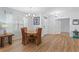 Bright dining room featuring a wood table set beneath a modern chandelier, with durable wood flooring at 7497 W Lenox Cir, Punta Gorda, FL 33950