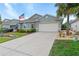 Inviting home with a well-kept lawn, lush landscaping, and a spacious driveway, perfect for a Gathering at 7497 W Lenox Cir, Punta Gorda, FL 33950