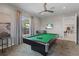 Inviting game room featuring a pool table, tv, and ample seating for entertainment at 7497 W Lenox Cir, Punta Gorda, FL 33950