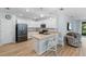 Stylish kitchen with an island, stainless steel appliances, and a breakfast bar, ideal for modern living at 7497 W Lenox Cir, Punta Gorda, FL 33950