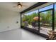 Covered lanai with patio dining set and gas grill overlooking the garden and landscaping at 7497 W Lenox Cir, Punta Gorda, FL 33950
