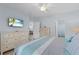 Spacious main bedroom featuring a ceiling fan, TV, wood-look flooring, and access to an attached bath at 7497 W Lenox Cir, Punta Gorda, FL 33950