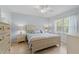 Inviting main bedroom with a ceiling fan, light-toned furniture, and plenty of natural light from a large window at 7497 W Lenox Cir, Punta Gorda, FL 33950